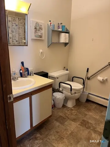 a utility room with a sink and wooden floor