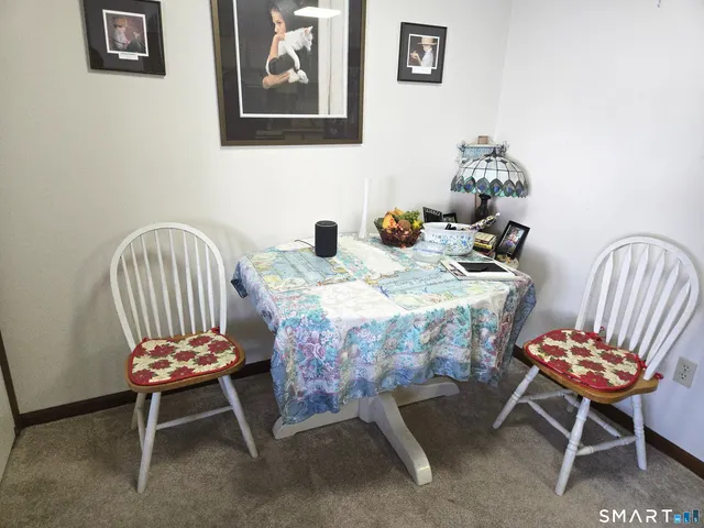 a dining room with furniture and wooden floor