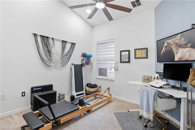 a view of a workspace with furniture and a window