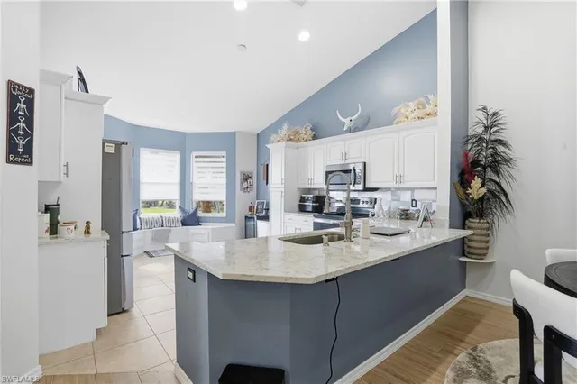 a kitchen with sink refrigerator and cabinets
