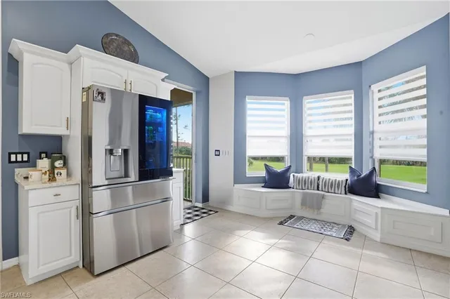 a kitchen with stainless steel appliances a refrigerator sink and cabinets