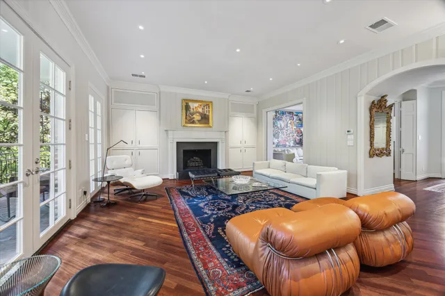 a spacious bathroom with a double vanity sink a toilet and a mirror