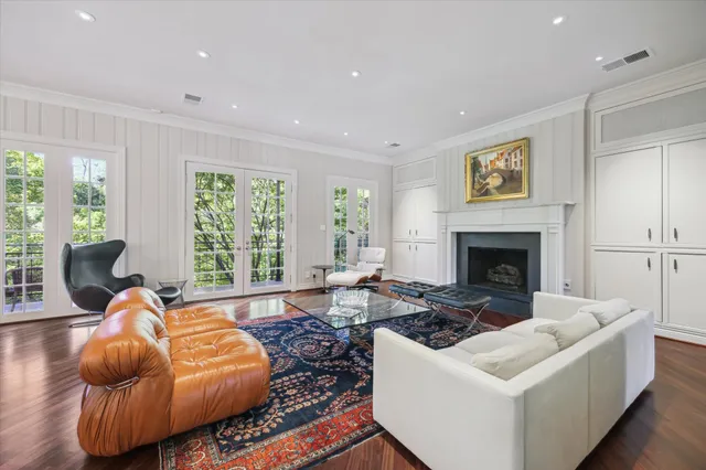 a living room with furniture a large window and a fireplace