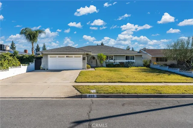 a house view with a swimming pool and a yard