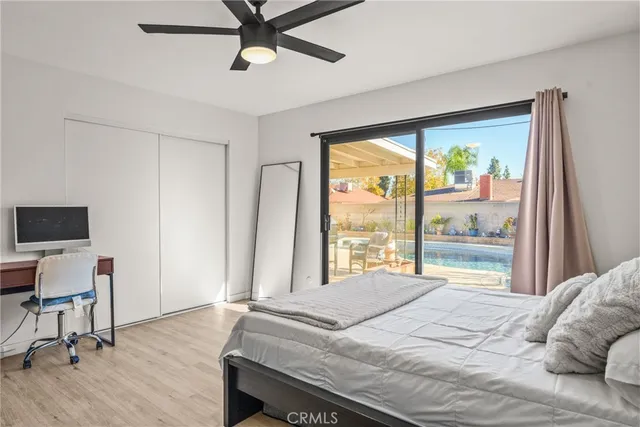 a bedroom with a bed and a large window