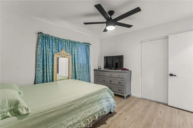 a bedroom with a bed and a television