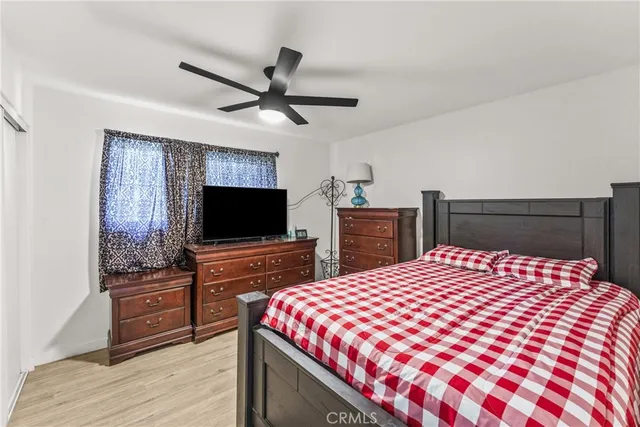 a bedroom with a bed and a flat screen tv