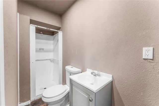 a white toilet sitting next to a bathroom sink