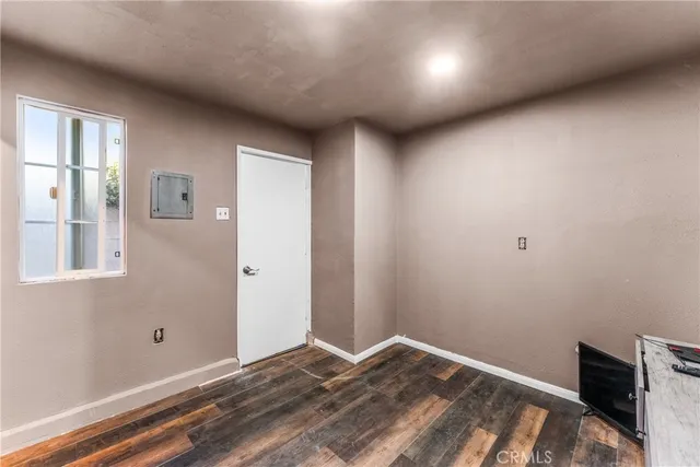 a view of a livingroom with wooden floor and a window
