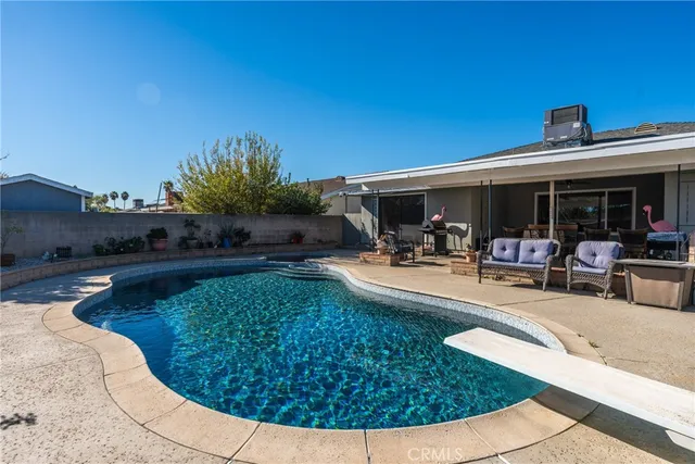 a view of a swimming pool with outdoor seating