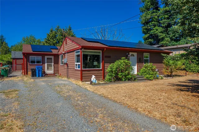 a view of a house with a yard and potted plants
