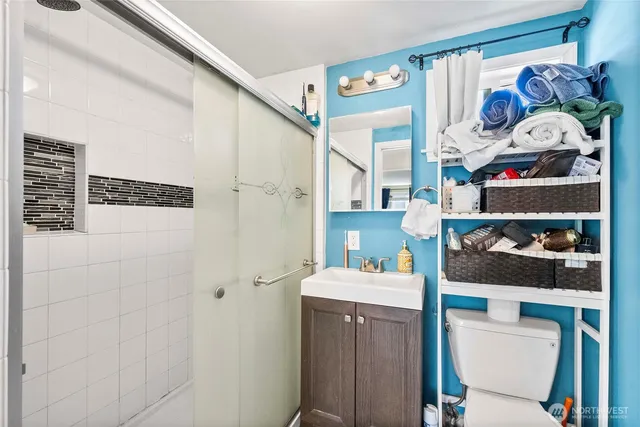 a bathroom with a sink vanity and shower
