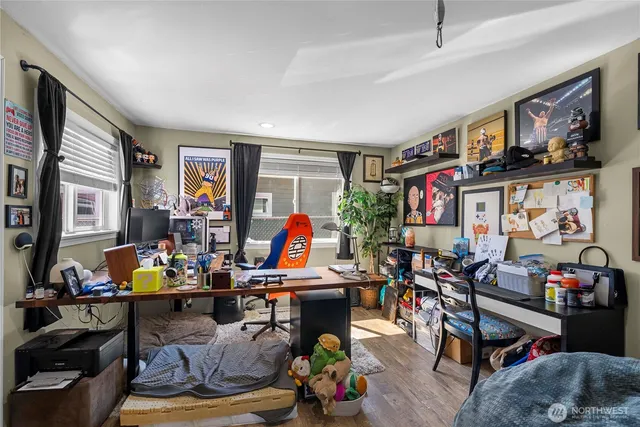 a view of backyard with a table and chairs and potted plants