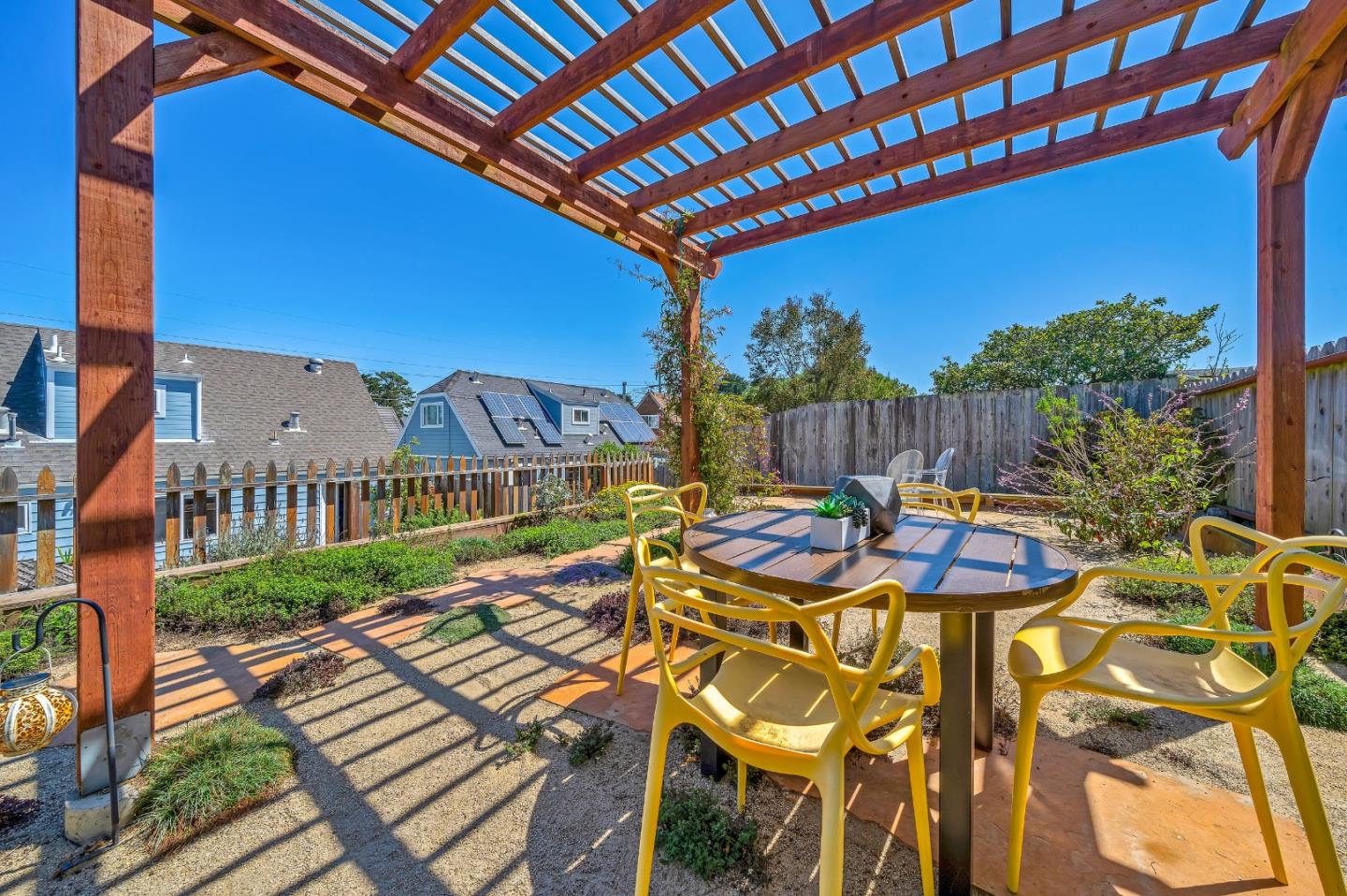428 Glasgow Drive Pacifica, CA 94044 - Photo 7 of 13 a view of a patio with table and chairs with wooden floor and fence