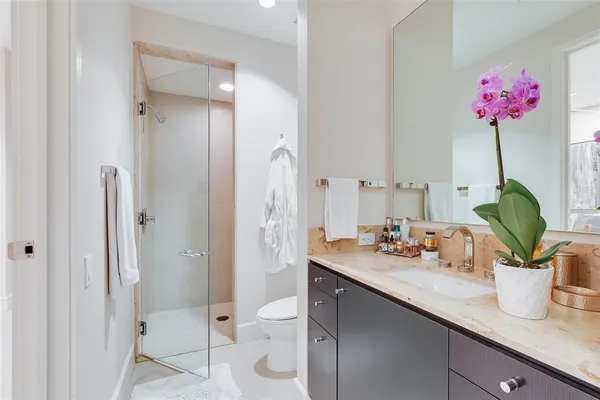 a bathroom with a sink a toilet and shower