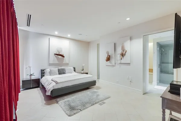 a spacious bedroom with a bed and a couch