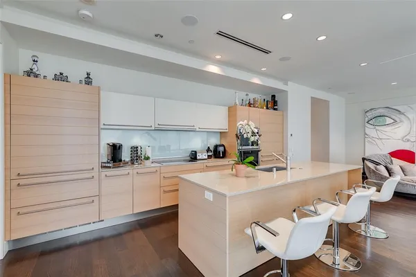 a kitchen with a sink cabinets and wooden floor