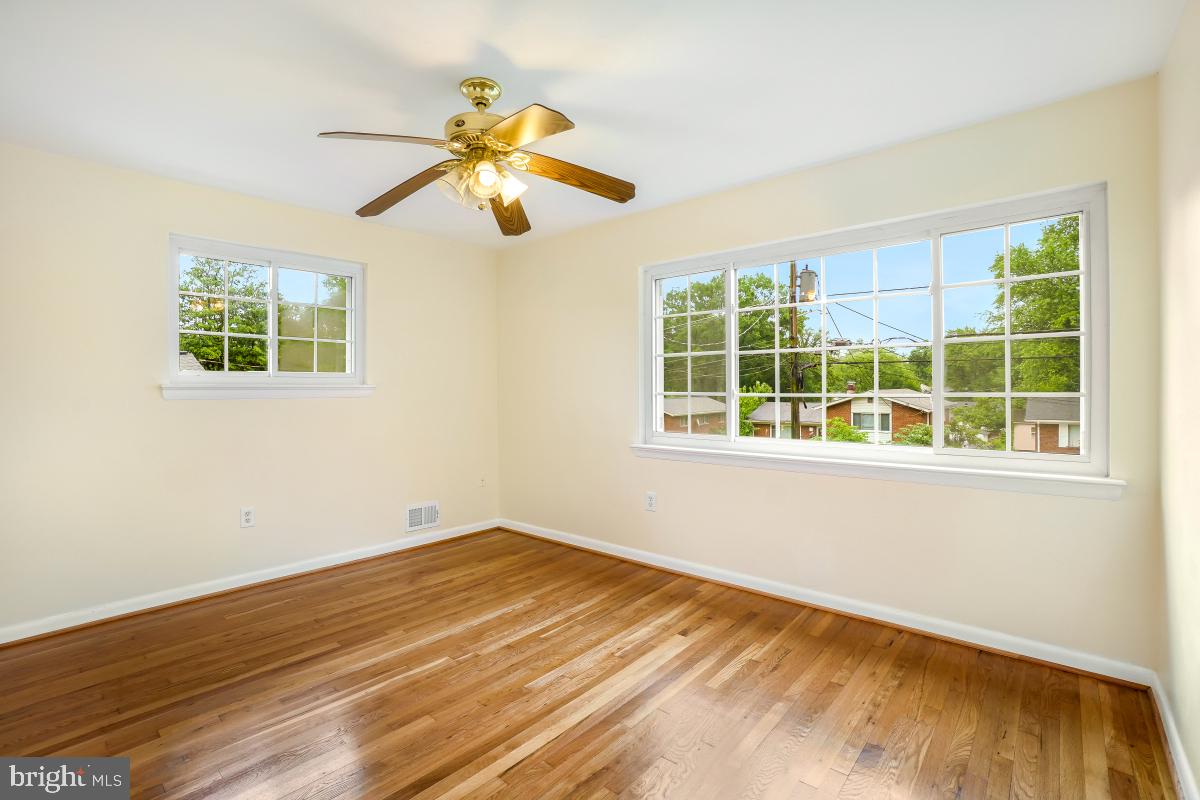 804 Gregorio Drive Silver Spring, MD 20901 - Photo 18 of 33 a view of empty room with wooden floor and fan