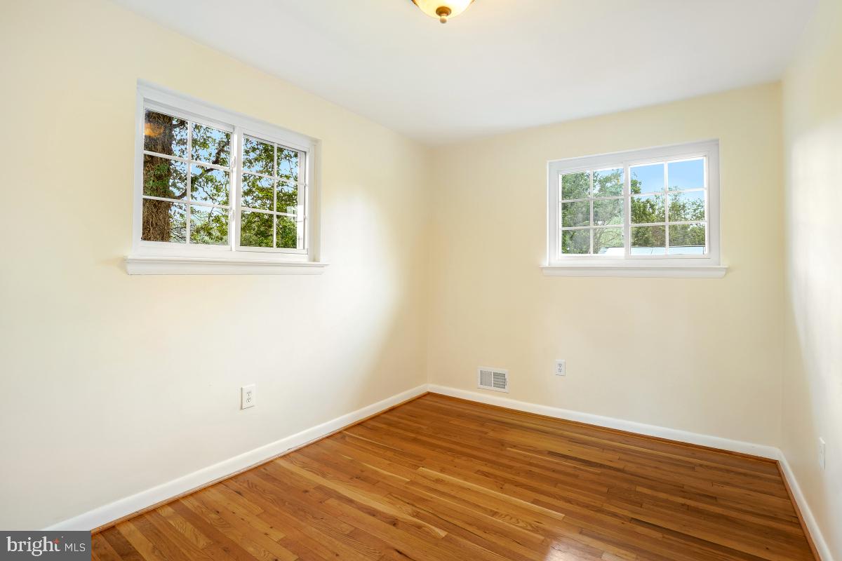 804 Gregorio Drive Silver Spring, MD 20901 - Photo 22 of 33 a view of an empty room with wooden floor and a window