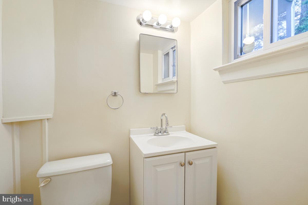 804 Gregorio Drive Silver Spring, MD 20901 - Photo 25 of 33 a bathroom with a toilet a sink a vanity and mirror