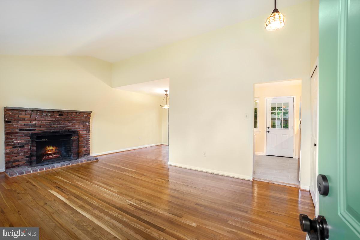804 Gregorio Drive Silver Spring, MD 20901 - Photo 5 of 33 a view of an empty room with wooden floor and a fireplace