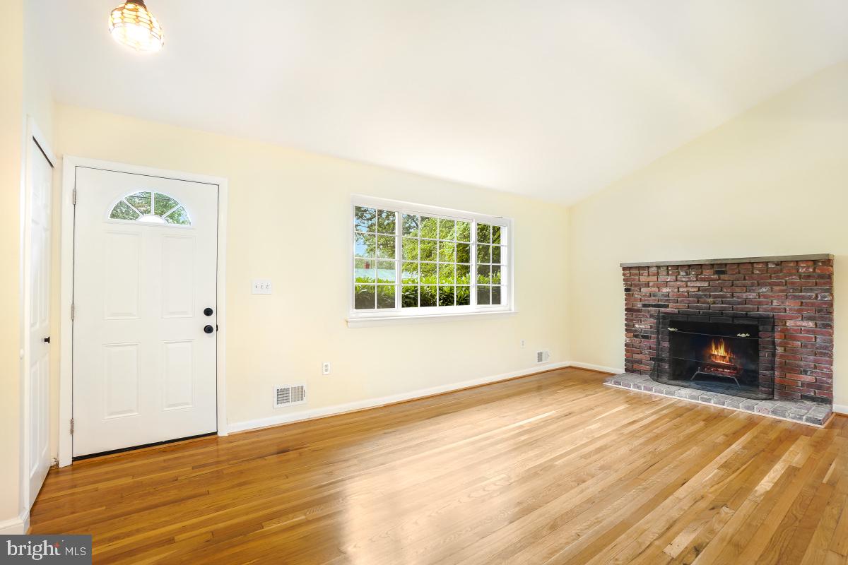 804 Gregorio Drive Silver Spring, MD 20901 - Photo 7 of 33 a view of an empty room with wooden floor and a window