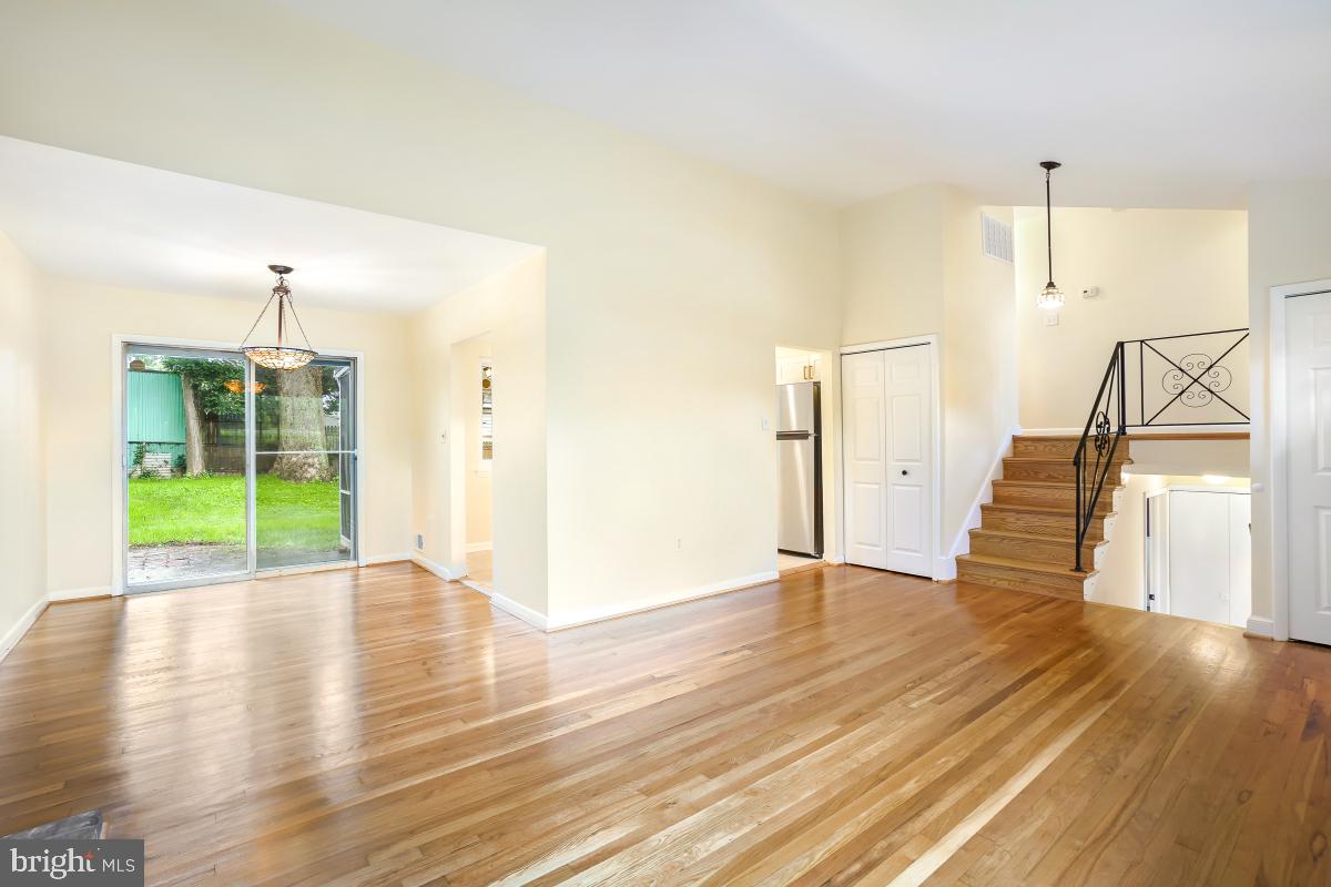 804 Gregorio Drive Silver Spring, MD 20901 - Photo 9 of 33 a view of an empty room with wooden floor and a kitchen