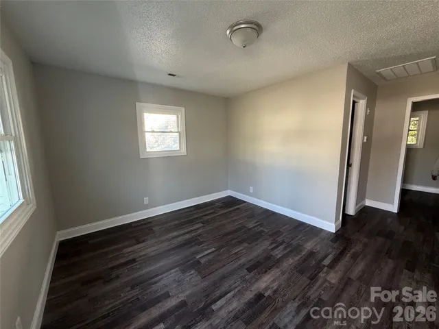 a bathroom with a bathtub shower sink vanity mirror and toilet