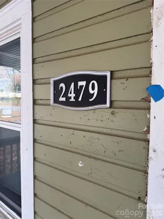 a living room with furniture a flat screen tv and a window