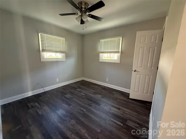 a kitchen with kitchen island granite countertop a sink stove and refrigerator