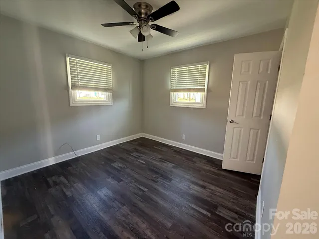 a kitchen with kitchen island granite countertop a sink stove and refrigerator