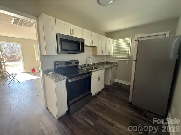 a bathroom with a bathtub shower sink vanity and a toilet