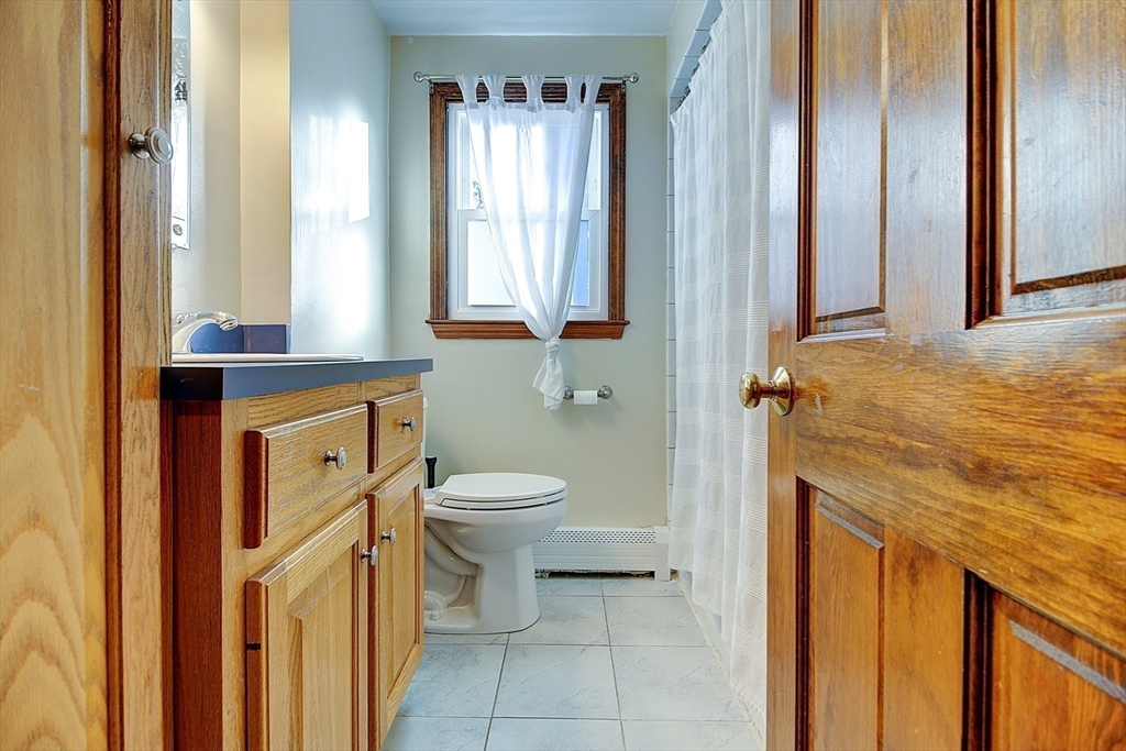 10 Stanford Road Franklin, MA 02038 - Photo 12 of 27 a bathroom with a granite countertop sink and a toilet