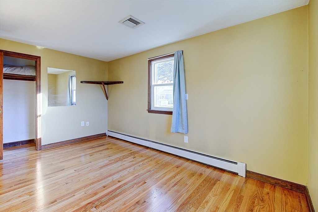 10 Stanford Road Franklin, MA 02038 - Photo 13 of 27 a view of an empty room with wooden floor and a window