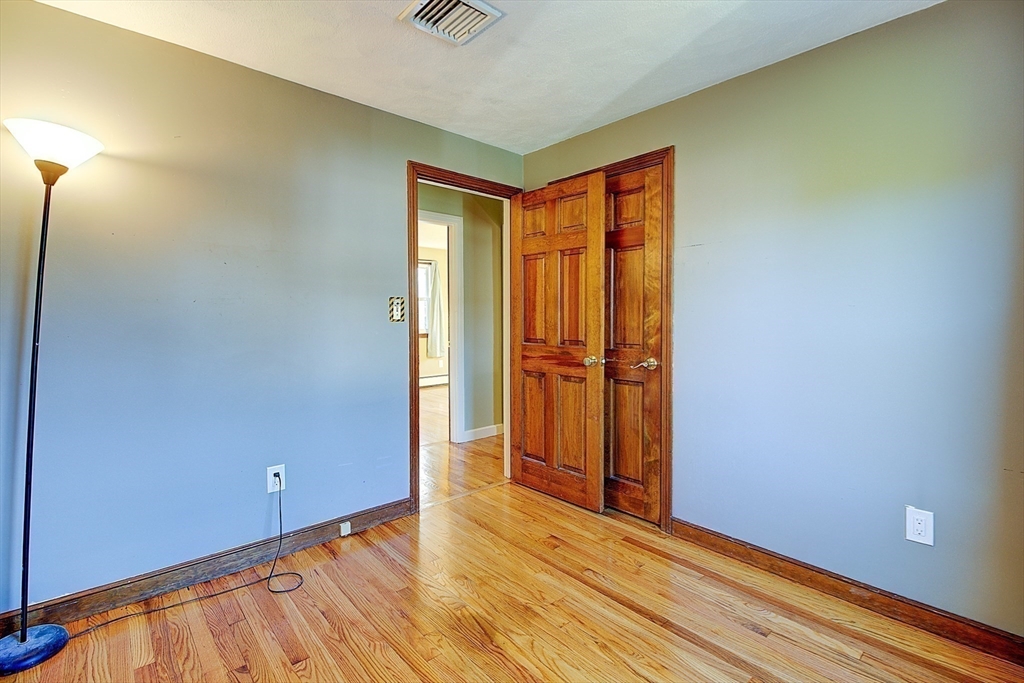 10 Stanford Road Franklin, MA 02038 - Photo 16 of 27 a view of an empty room with closet and wooden floor