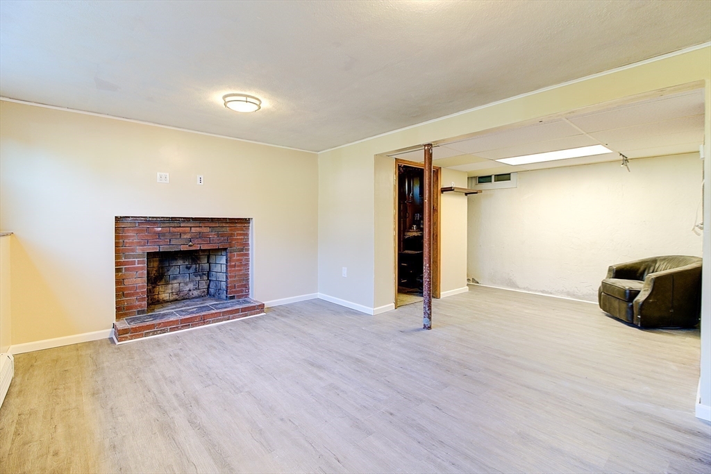 10 Stanford Road Franklin, MA 02038 - Photo 20 of 27 a view of an empty room with wooden floor fireplace and a window