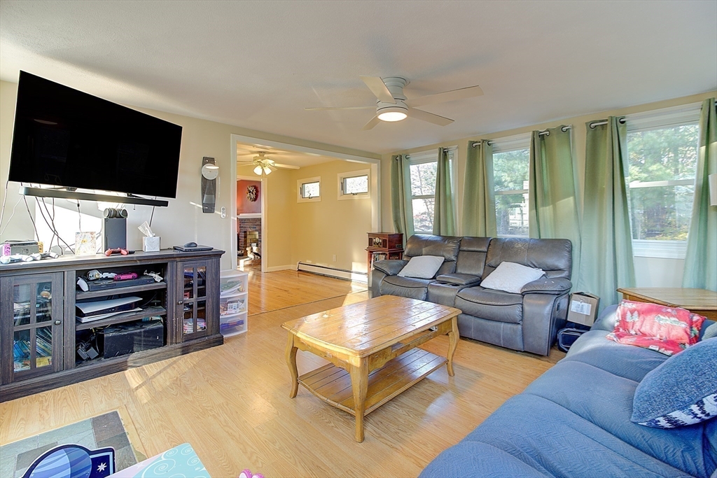10 Stanford Road Franklin, MA 02038 - Photo 4 of 27 a living room with furniture and a flat screen tv
