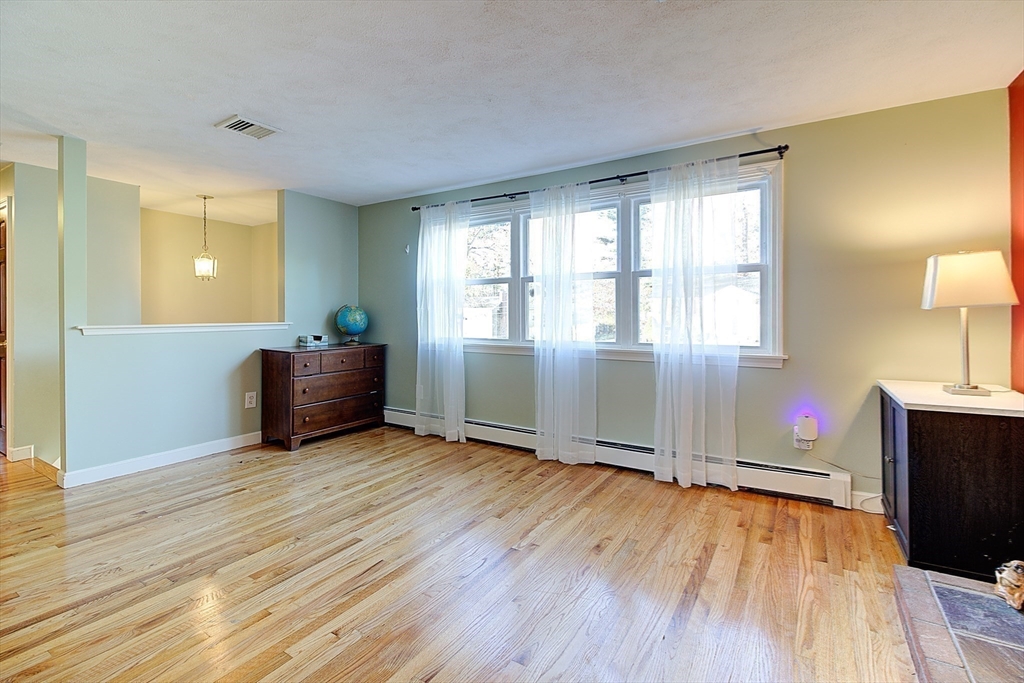 10 Stanford Road Franklin, MA 02038 - Photo 8 of 27 a view of an empty room with wooden floor and a window