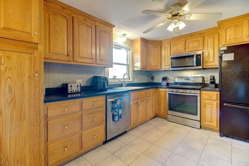 10 Stanford Road Franklin, MA 02038 - Photo 10 of 27 a kitchen with stainless steel appliances granite countertop a stove sink microwave and refrigerator