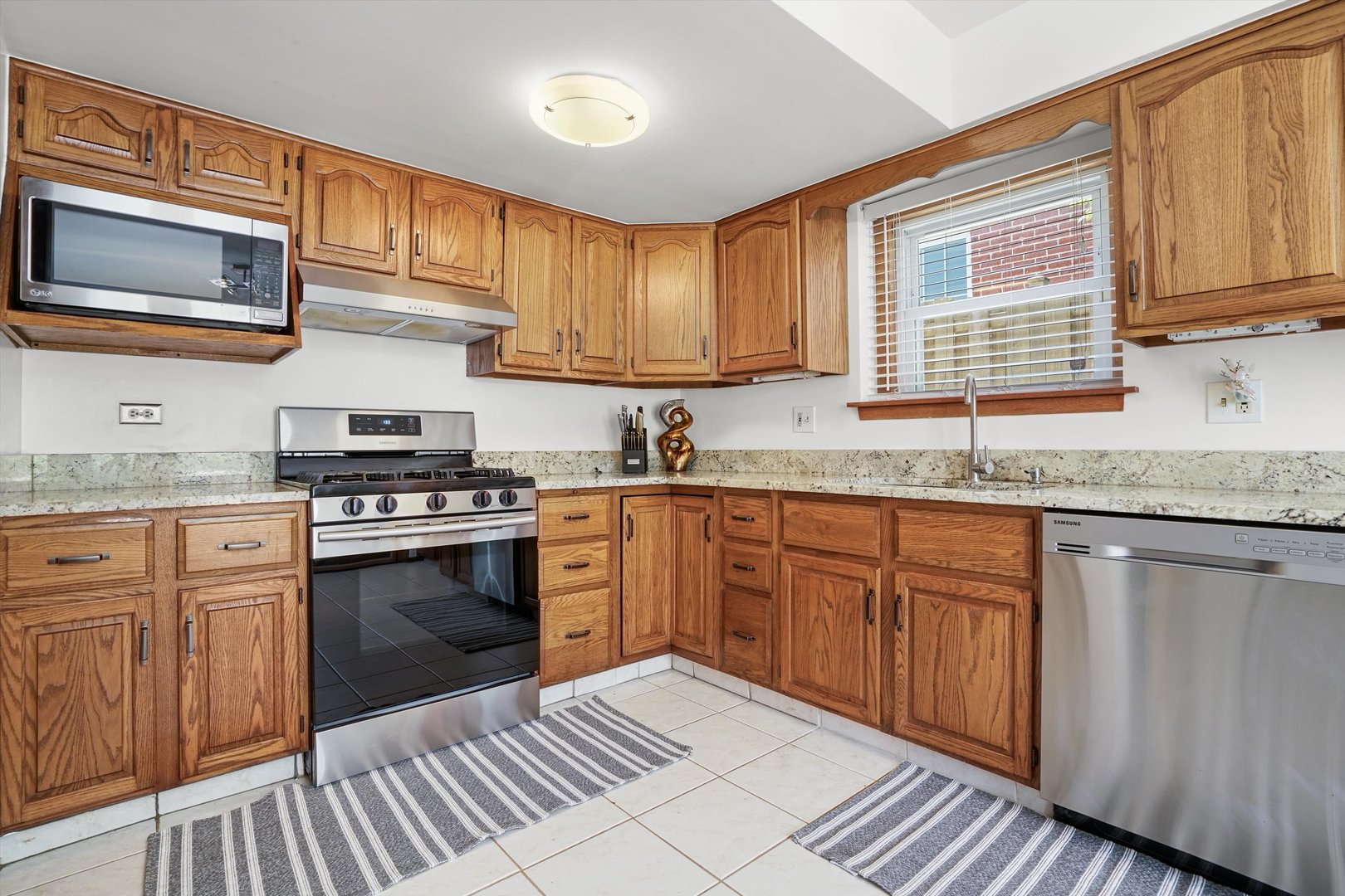2130 Birch Street Park Ridge, IL 60068 - Photo 18 of 47 a kitchen with granite countertop cabinets stainless steel appliances a sink and window