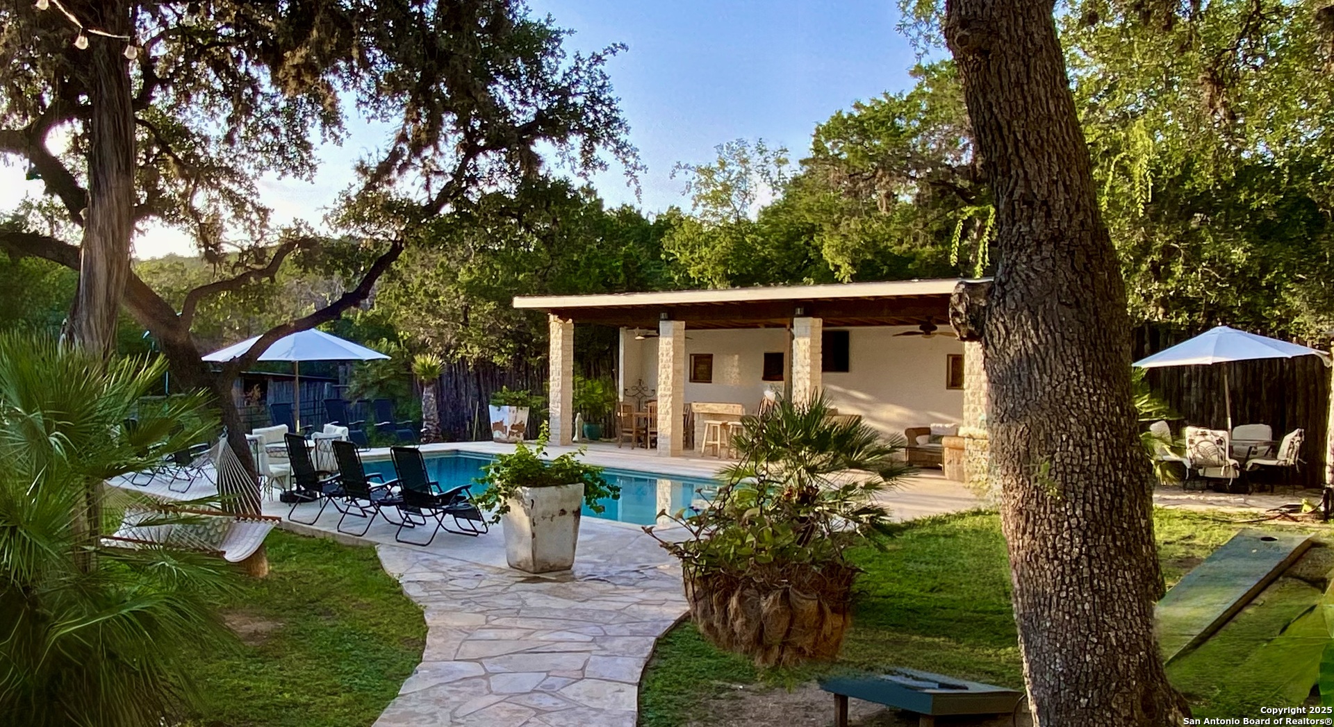 512 County Road 348 Concan, TX 78838 - Photo 12 of 39 a view of a house with backyard sitting area and garden