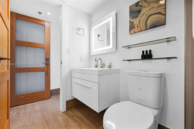 a bathroom with a toilet sink and mirror