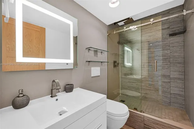 a bathroom with a sink toilet and shower