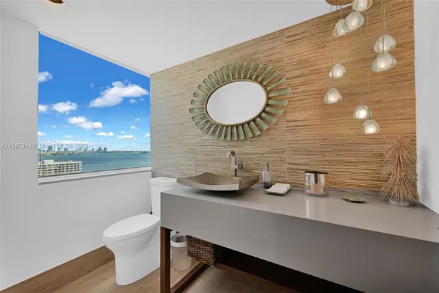 a bathroom with a sink a mirror and a toilet