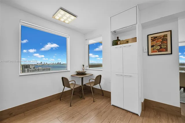 a dining room with wooden floor and a chandelier