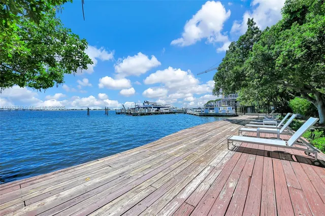 a view of a couches in patio with a yard