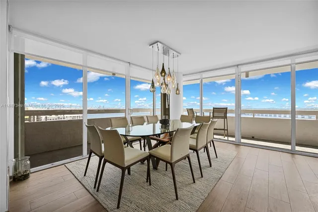 a dining room with furniture a chandelier and wooden floor