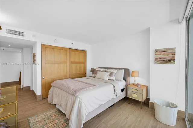 a bedroom with a bed and a couch