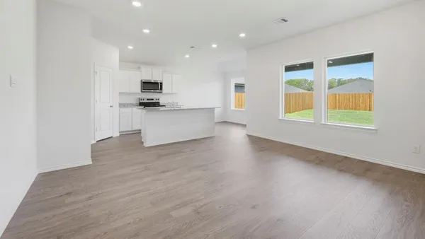 a open kitchen with kitchen island a sink stainless steel appliances and cabinets