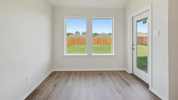 a view of kitchen with white cabinets and stainless steel appliances